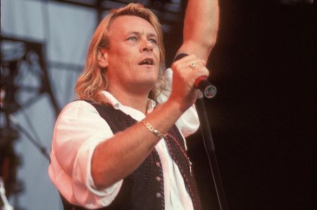 Brian Howe singing at a concert.
